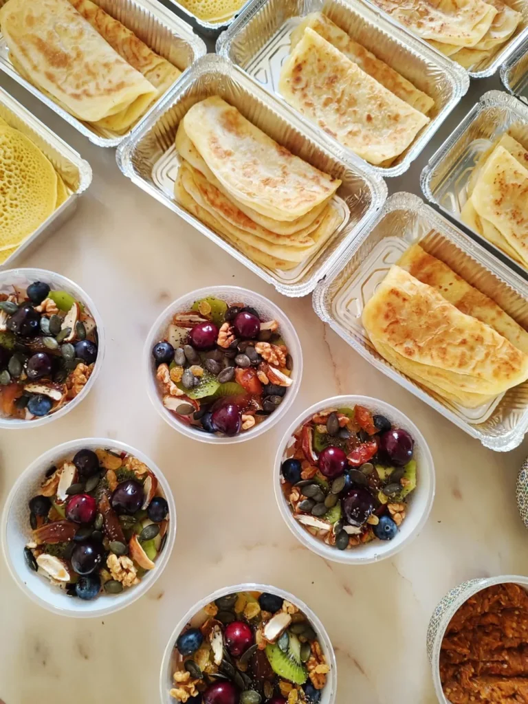 Moroccan vegan breakfast spread with pancakes, salads and fruit